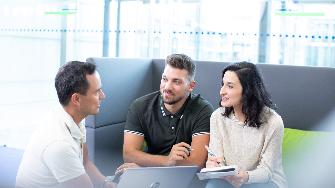 
Eine Mitarbeiterin und zwei Mitarbeiter im Gespräch