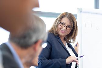 
Frau spricht zur Gruppe