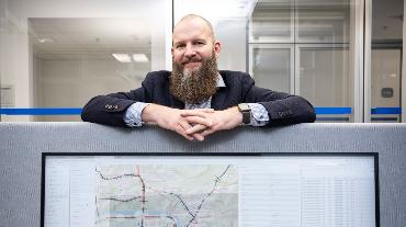 
Mitarbeiter hinter großem Bildschirm mit Mobilitätsdaten